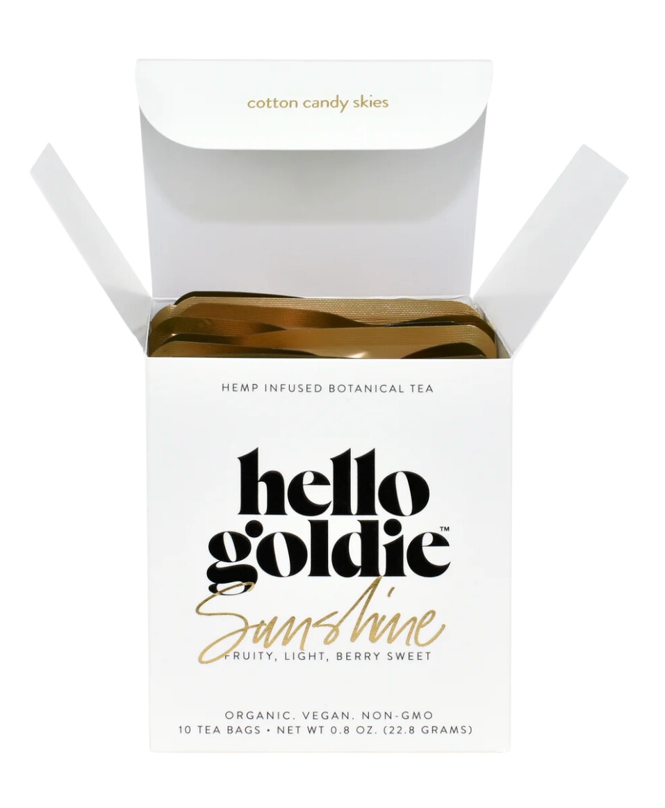 A box of Hello Goldie Sunshine Botanical Tea with the product's description and organic, vegan, non-GMO certifications displayed on the packaging.