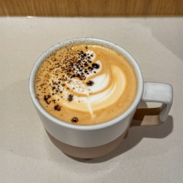 Dubai Mocha with espresso, pistachio chocolate foam, and cocoa gold topper served at a Denver coffee shop