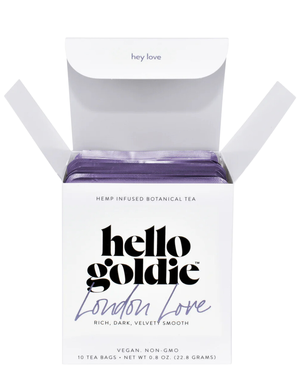 Packaging of Hello Goldie London Love Botanical Tea, with the product visible through an open white box. The tea is described as hemp-infused, with a dark, rich, velvety smooth, and it's presented as vegan, non-GMO, with 10 tea bags included.