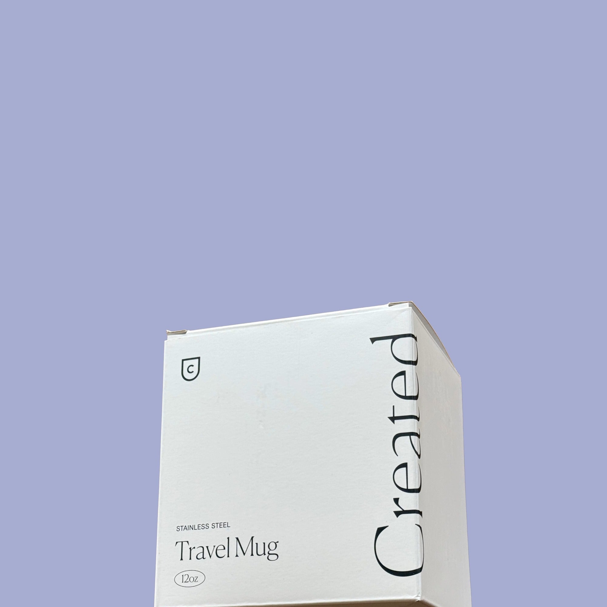 Box of a travel mug with 'Created' branding on a light purple background