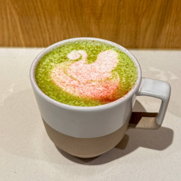 Merry Matcha Latte with Rishi matcha and pomegranate cranberry topper at a specialty coffee shop in Denver