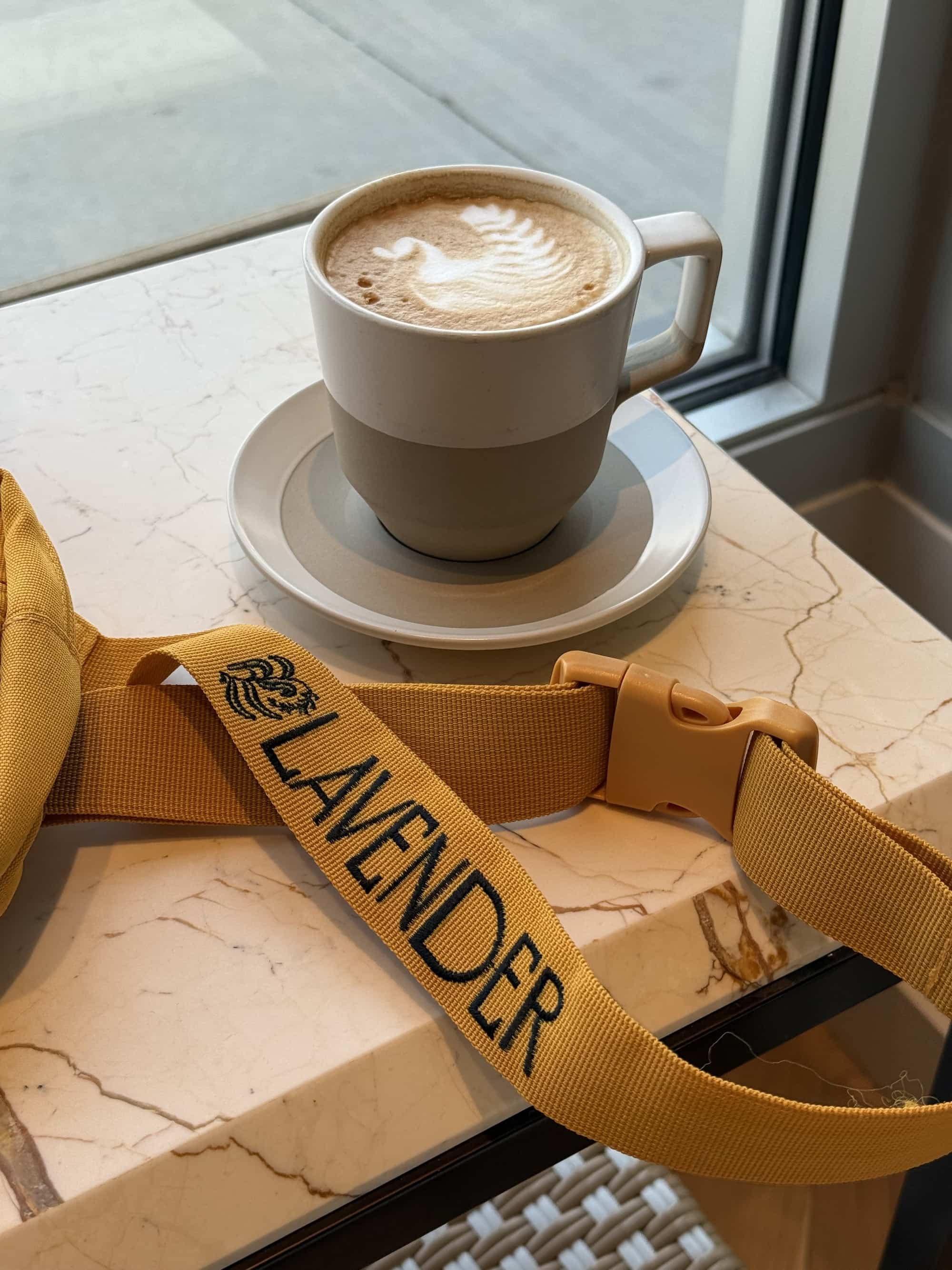 Lavender fanny pack and latte in coffee shop